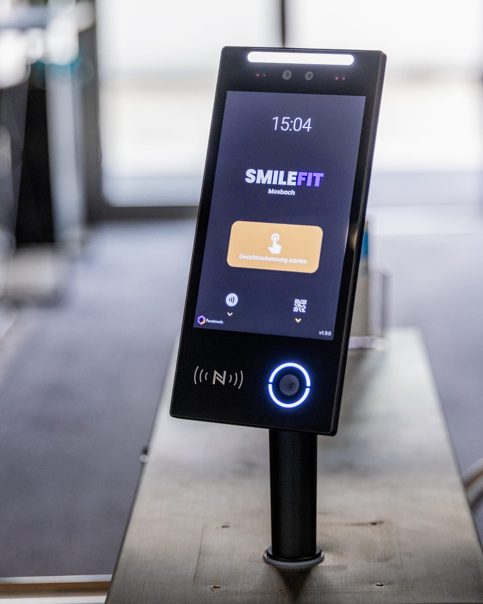 IDA reader with display, camera, RFID pad and QR scanner on a stand at the studio entrance