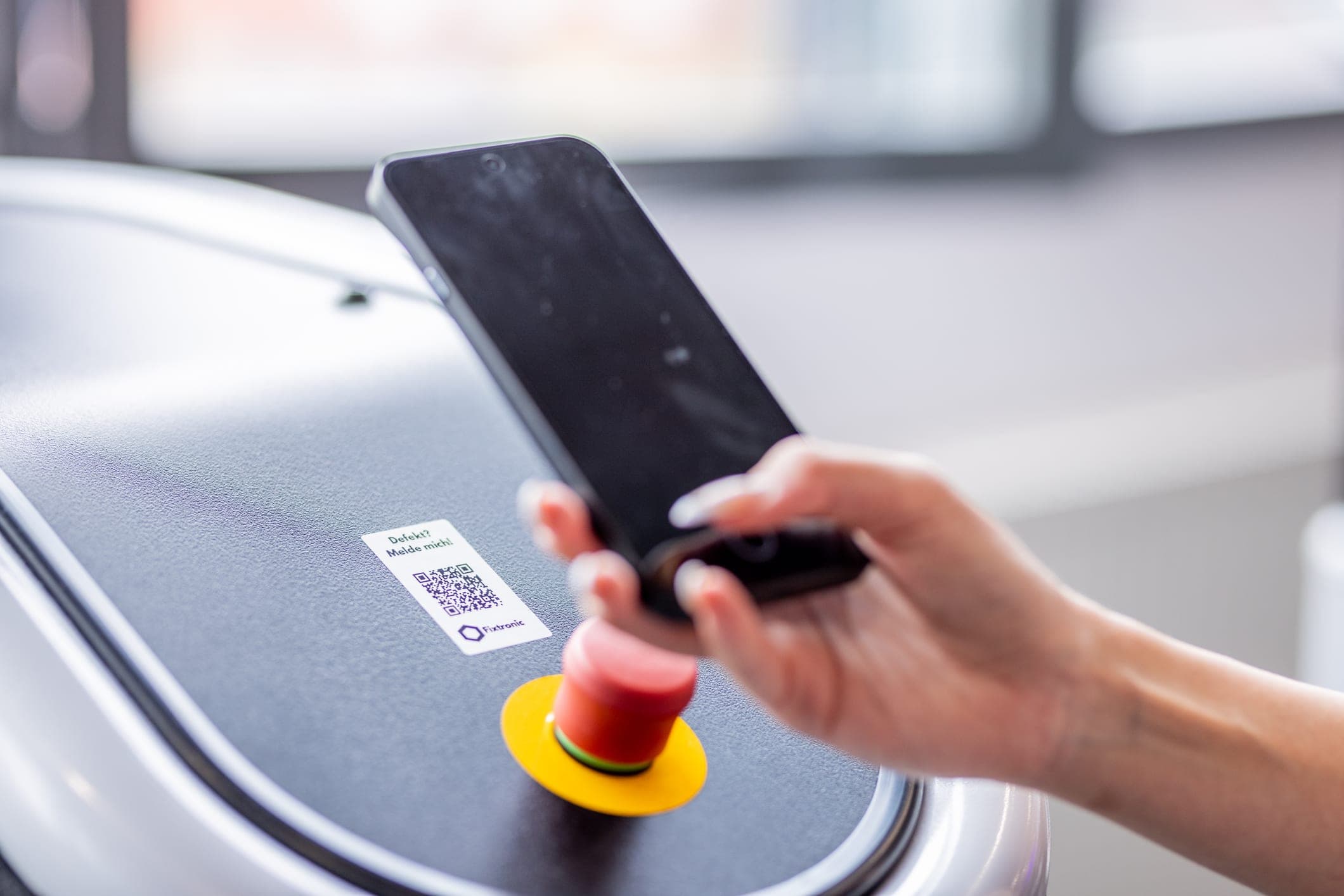 Member scanning the Fixtronic QR code on a training machine with their smartphone